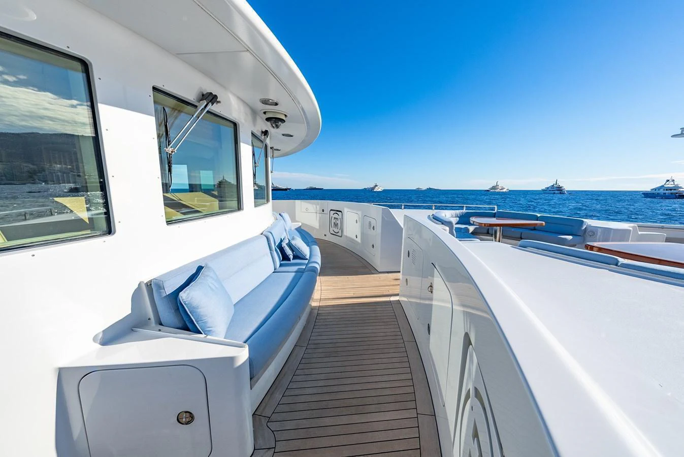 The side deck offers a serene space with comfortable seating and stunning ocean views. aboard LATITUDE Yacht for Sale