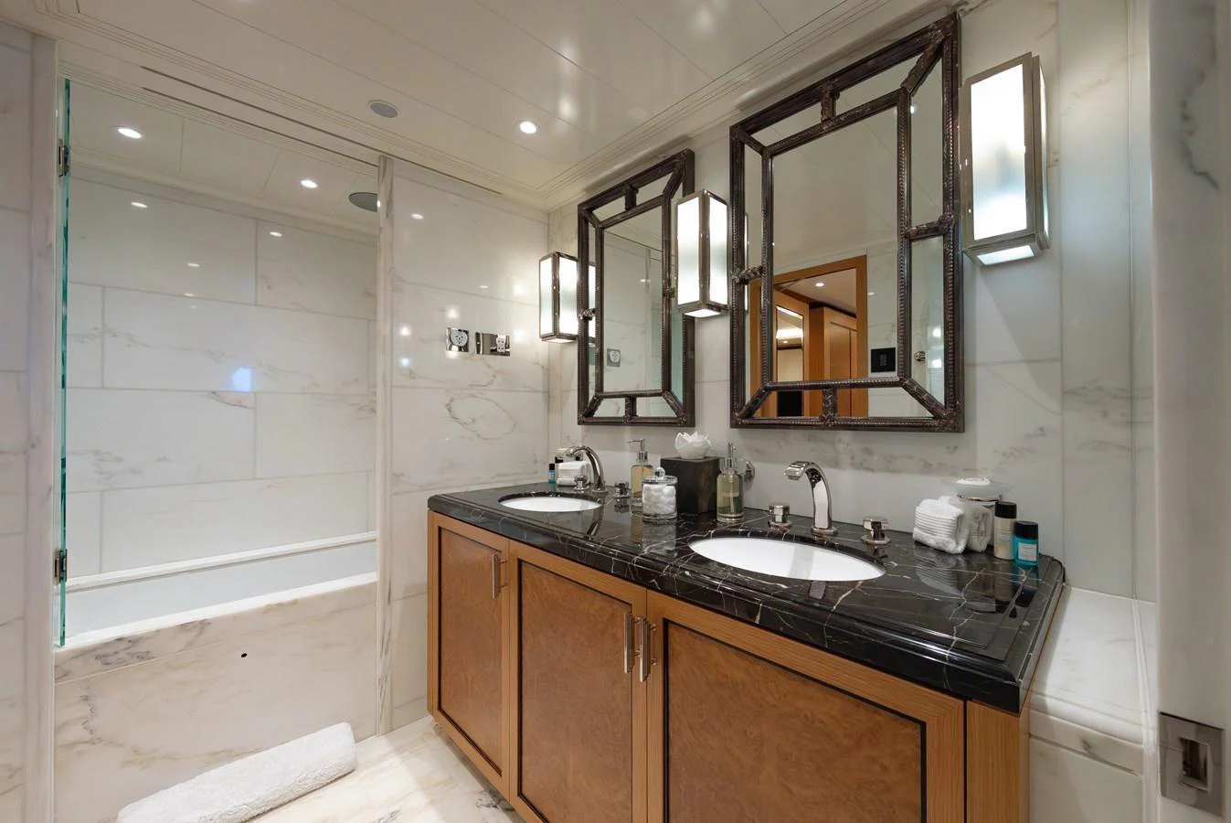 The yacht's bathroom features elegant marble surfaces and dual sinks for a luxurious experience. aboard LATITUDE Yacht for Sale