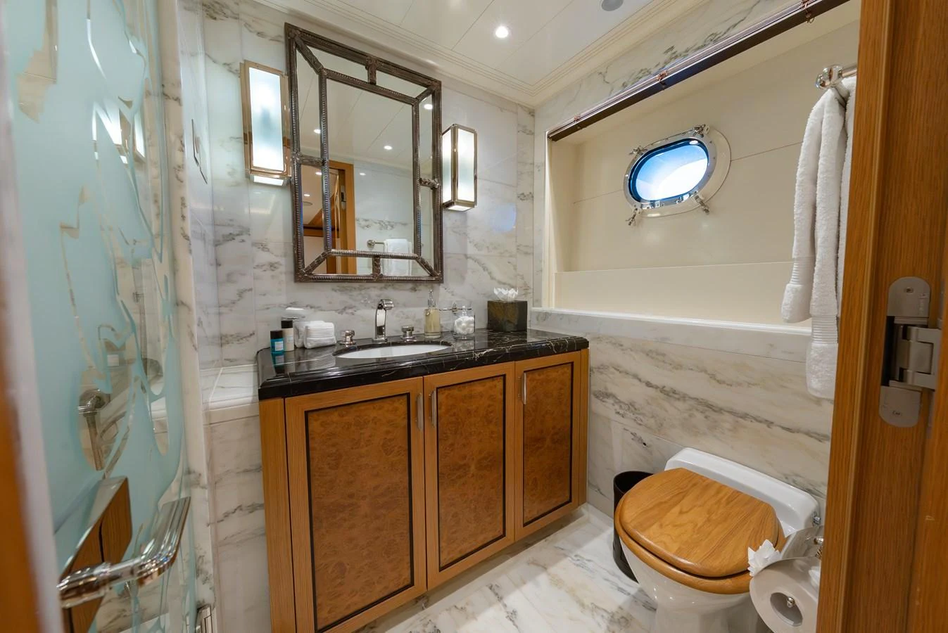 The yacht's bathroom features elegant marble surfaces and high-end fixtures. aboard LATITUDE Yacht for Sale