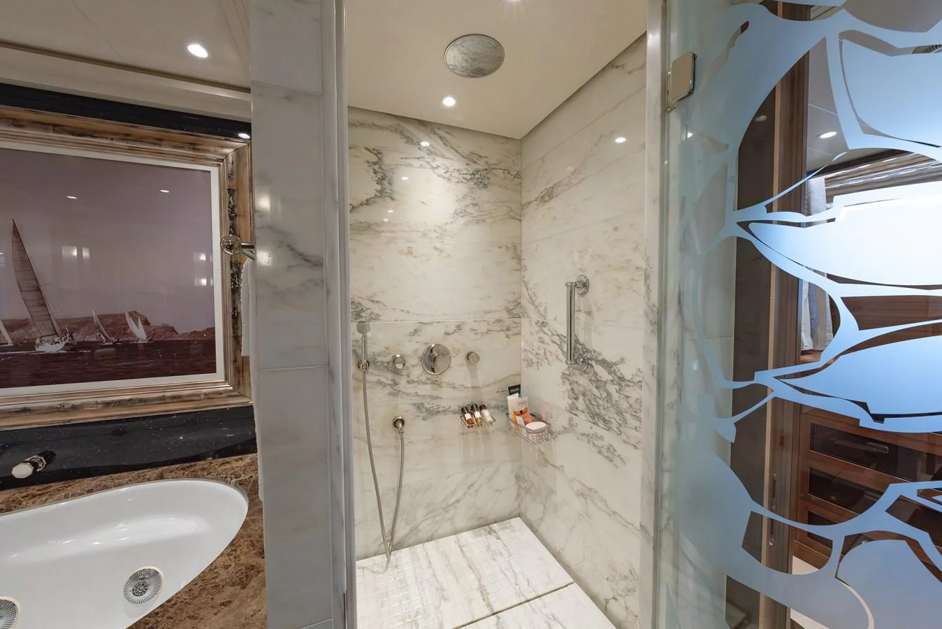 The yacht's bathroom features elegant marble finishes and modern fixtures. aboard LATITUDE Yacht for Sale