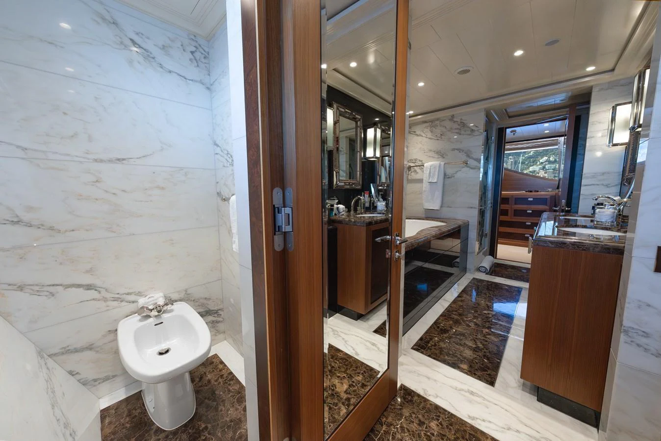 The yacht's bathroom features luxurious marble finishes and modern fixtures. aboard LATITUDE Yacht for Sale