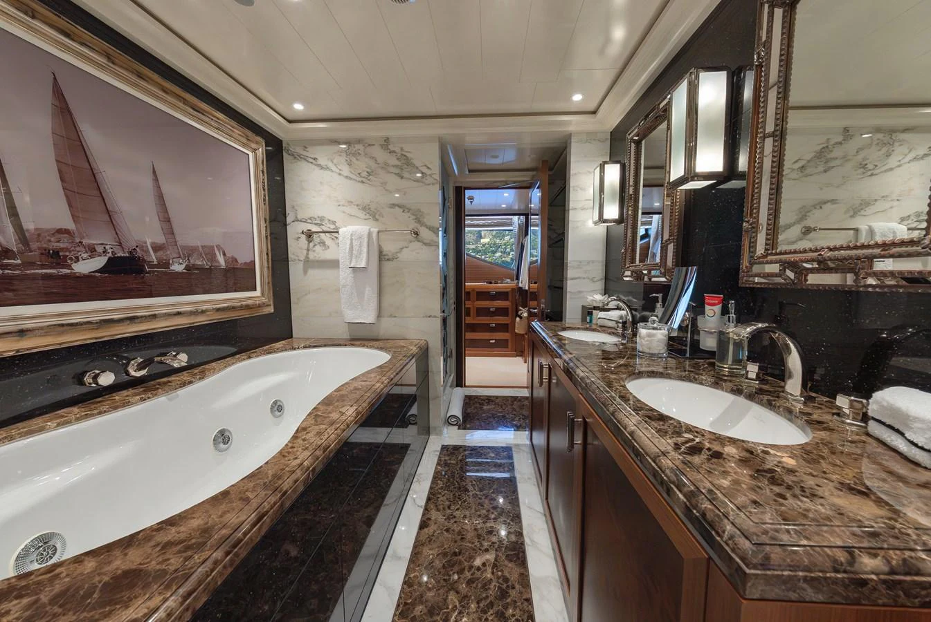 A luxurious yacht bathroom featuring a marble countertop and a spacious bathtub. aboard LATITUDE Yacht for Sale