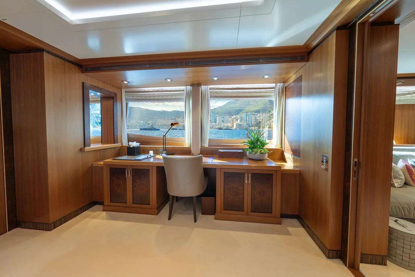 A luxurious yacht office with a scenic view through large windows. aboard LATITUDE Yacht for Sale