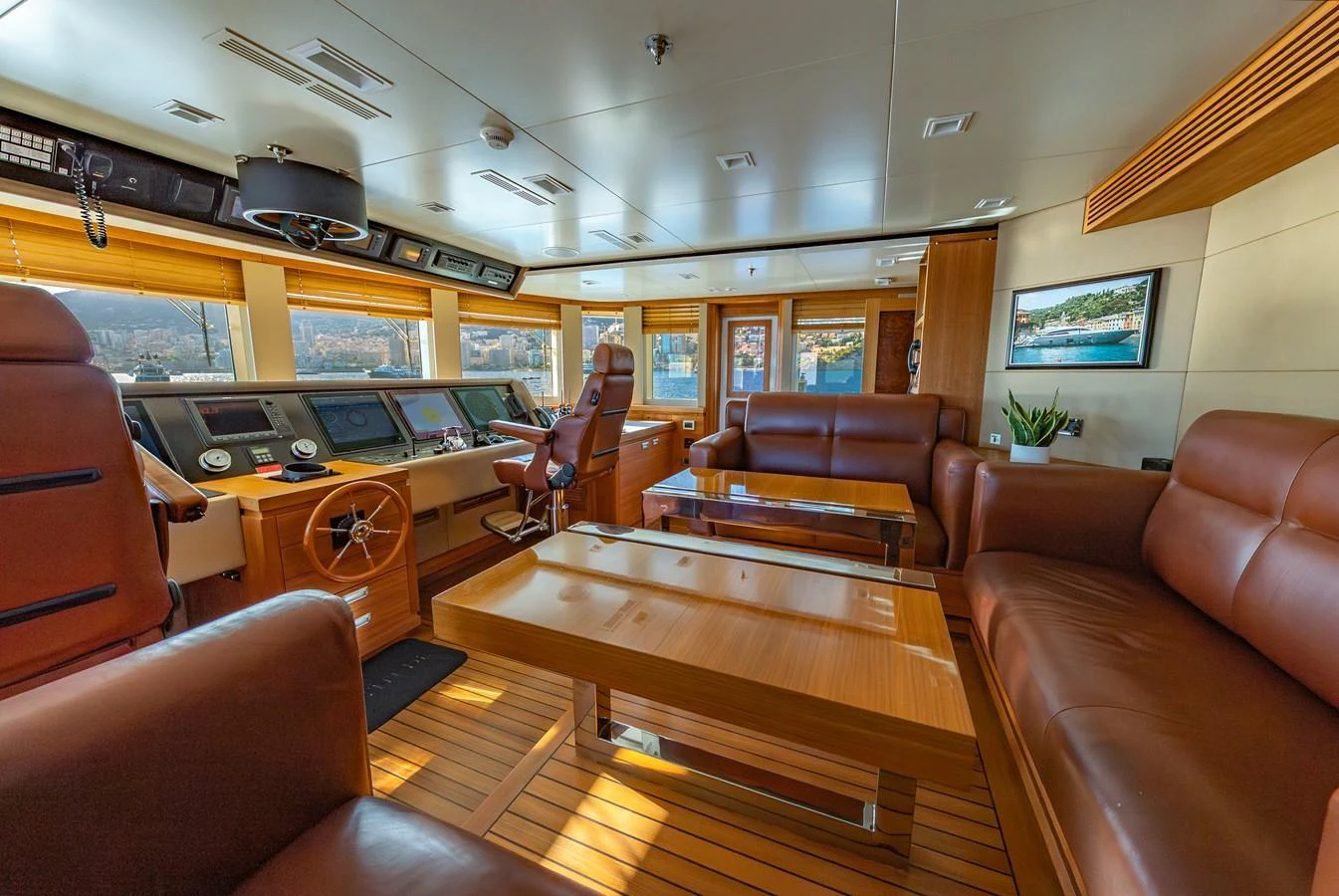 The helm area features luxurious seating and state-of-the-art navigation equipment, offering a comfortable and sophisticated command center. aboard LATITUDE Yacht for Sale