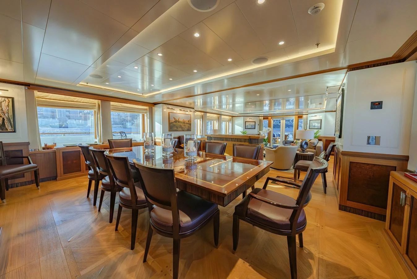 The yacht's dining area features elegant wood furnishings and ample seating, creating a refined atmosphere for meals. aboard LATITUDE Yacht for Sale
