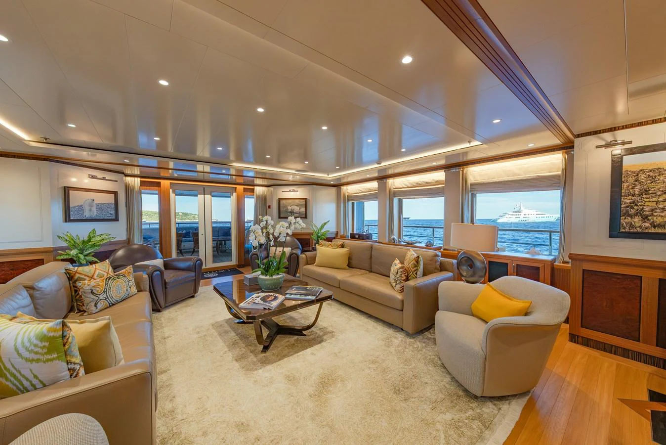 The salon offers a spacious and elegantly furnished area with ample seating and large windows providing stunning ocean views. aboard LATITUDE Yacht for Sale