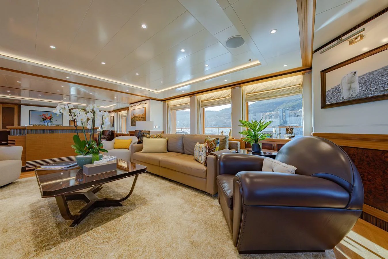 The salon features luxurious seating with elegant decor and ample natural light. aboard LATITUDE Yacht for Sale