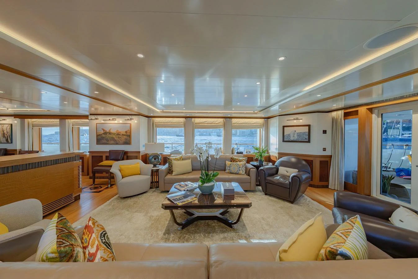 The spacious salon features elegant seating arrangements and large windows offering stunning views. aboard LATITUDE Yacht for Sale