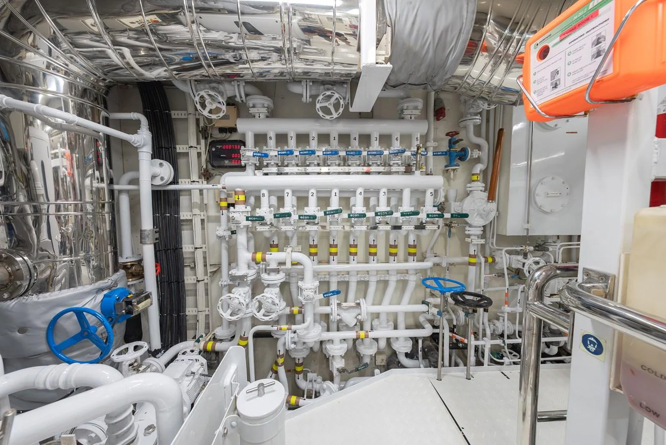 The engine room showcases a complex array of pipes, valves, and machinery, reflecting the yacht's advanced engineering. aboard LATITUDE Yacht for Sale