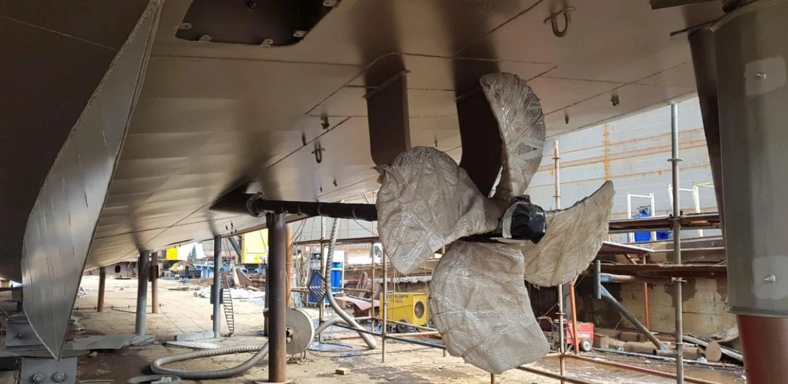 The image showcases the underside of a yacht, highlighting the propeller and surrounding mechanical components. aboard NIRVANA Yacht for Sale