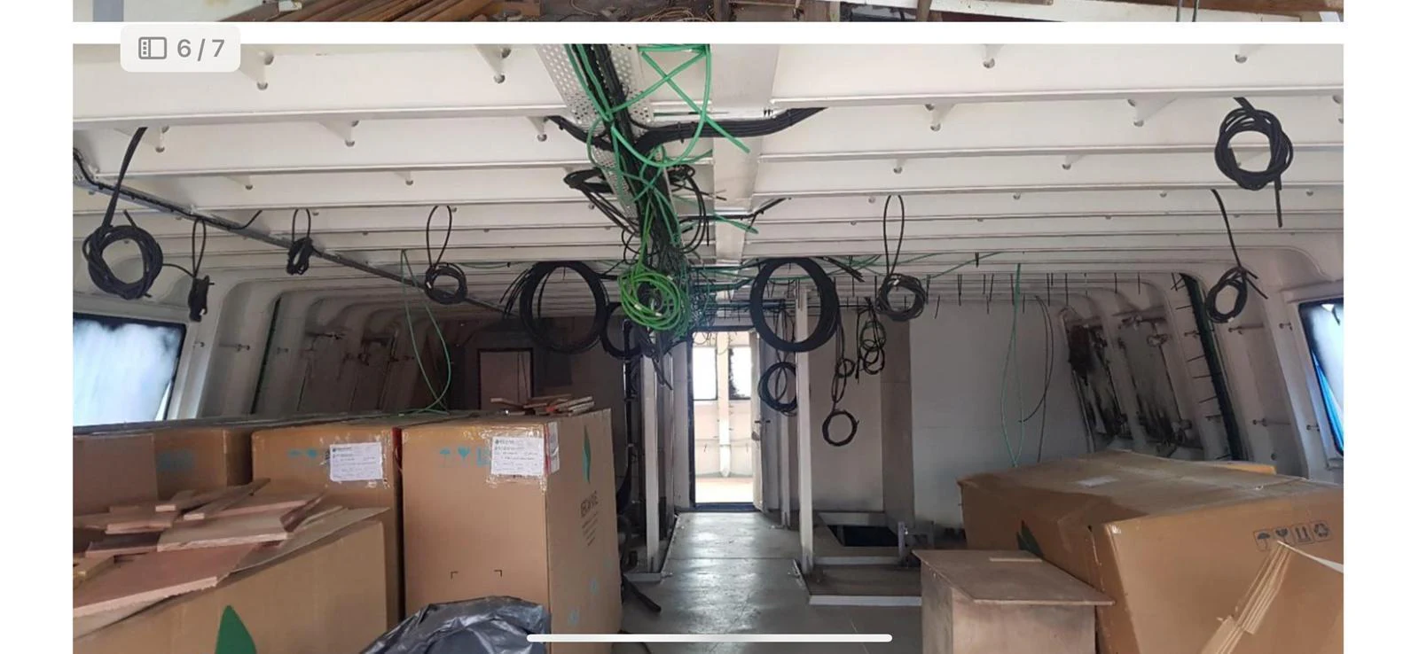 The image shows an unfinished interior space of a yacht with various cables and boxes scattered around. aboard NIRVANA Yacht for Sale