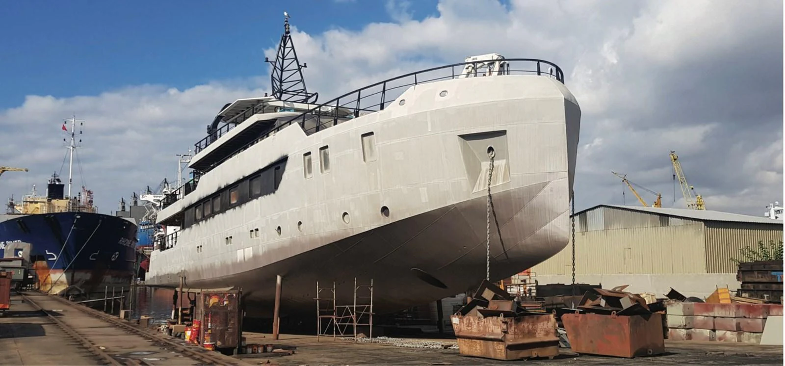 The yacht is docked on land, undergoing maintenance or construction. aboard NIRVANA Yacht for Sale