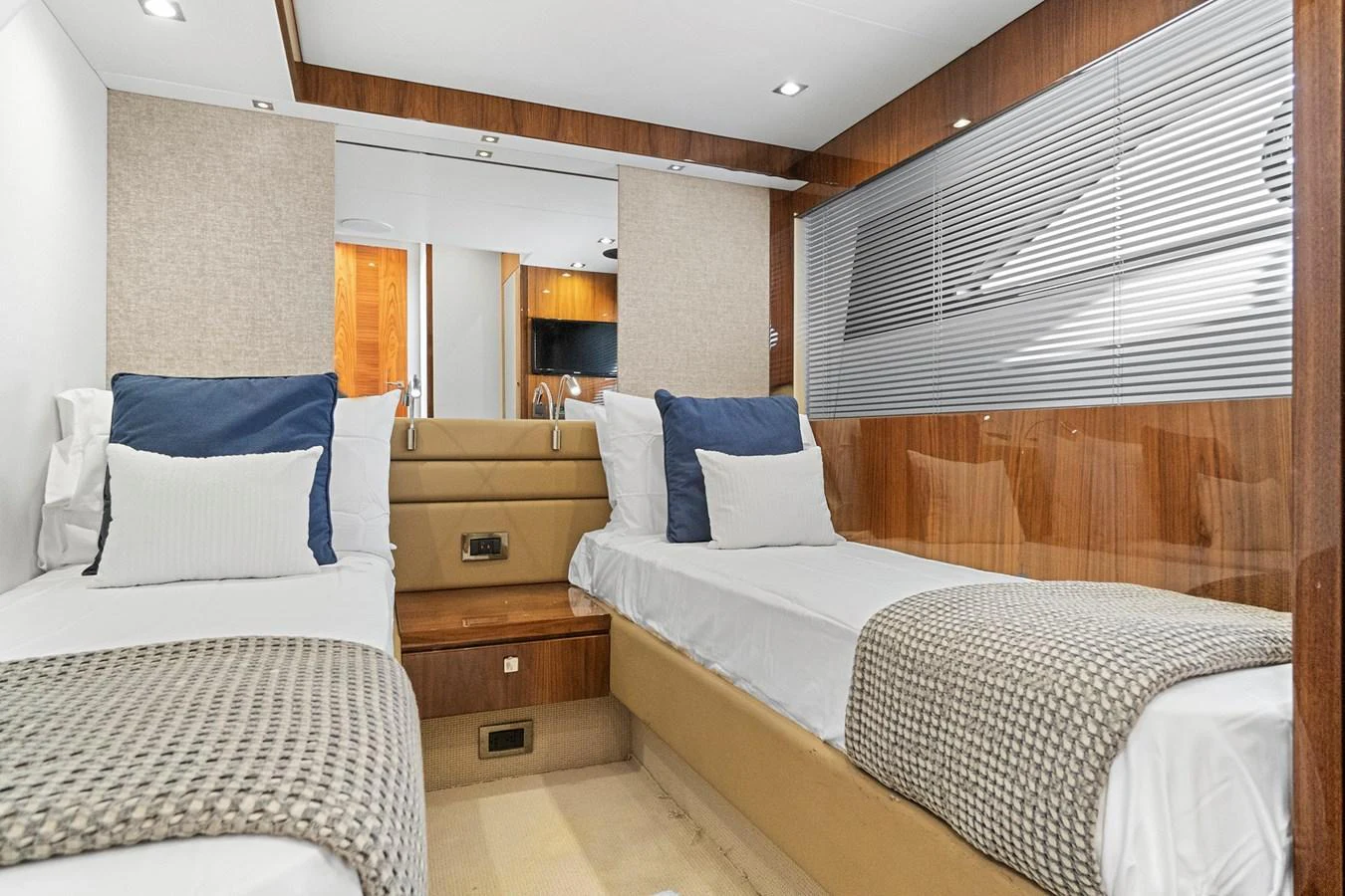 The guest cabin features twin beds with plush bedding and modern decor. aboard EXIT Yacht for Sale