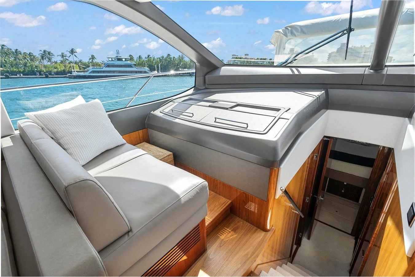 The yacht's salon offers a comfortable seating area with a view of the water through large windows. aboard EXIT Yacht for Sale