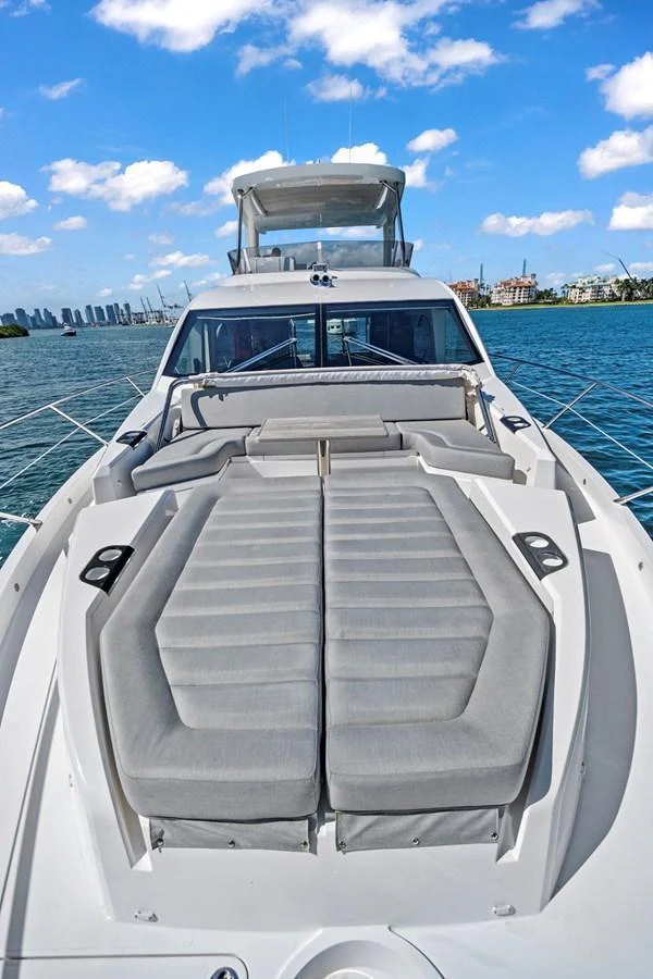 The yacht's foredeck features luxurious sun pads for ultimate relaxation under the open sky. aboard EXIT Yacht for Sale