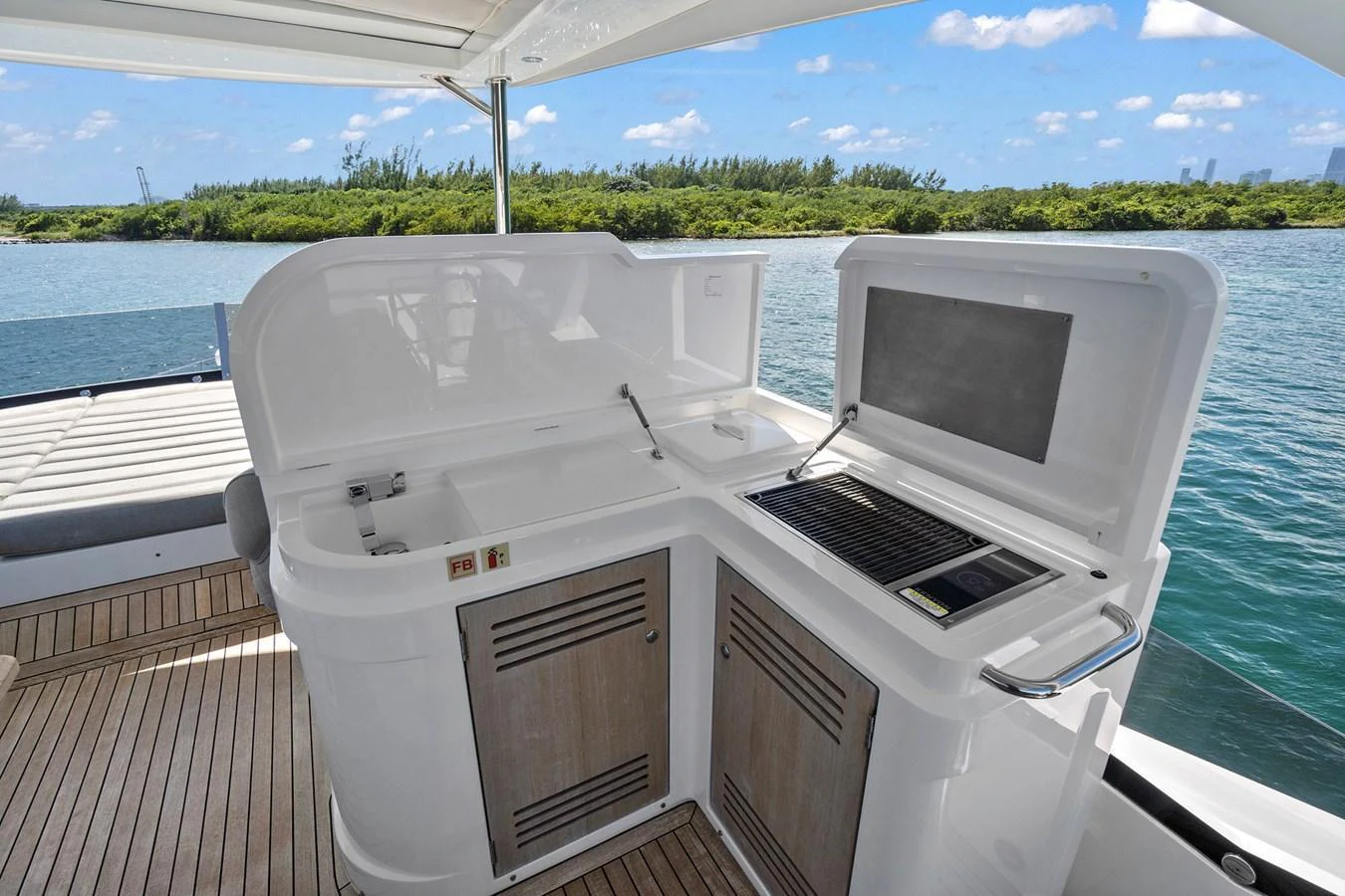 The yacht features a well-equipped outdoor galley with a grill and sink, perfect for alfresco dining. aboard EXIT Yacht for Sale