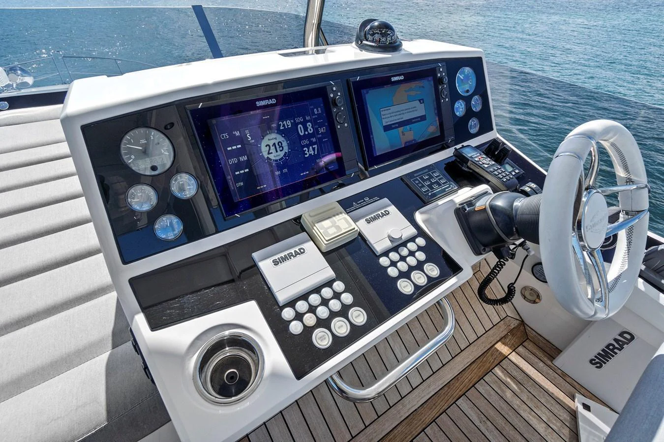 The helm station features advanced navigation equipment and a sleek, modern design. aboard EXIT Yacht for Sale