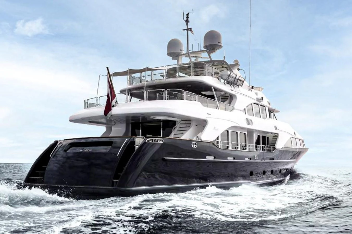 A luxurious yacht cruises through the open sea, showcasing its elegant design and spacious decks. aboard SOHO Yacht for Sale