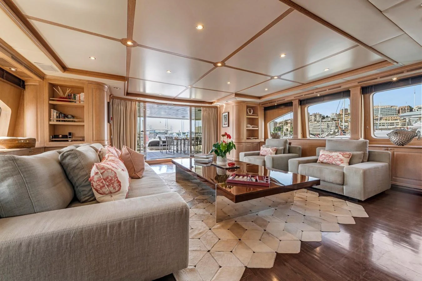 The salon offers a spacious and elegantly furnished area with ample seating and large windows providing stunning views. aboard SOHO Yacht for Sale