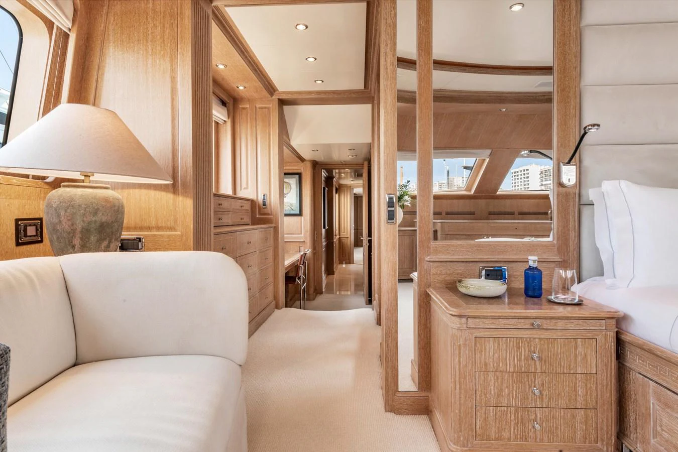 The stateroom features elegant wood paneling and luxurious furnishings, creating a warm and inviting atmosphere. aboard SOHO Yacht for Sale