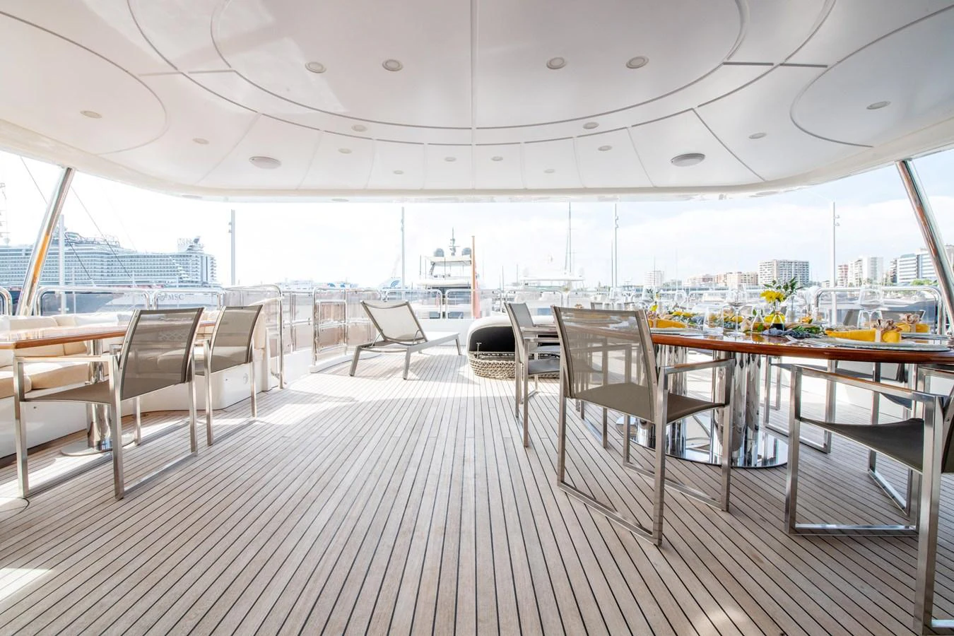 The aft deck offers a spacious and elegant area for dining and relaxation with a stunning view of the marina. aboard SOHO Yacht for Sale