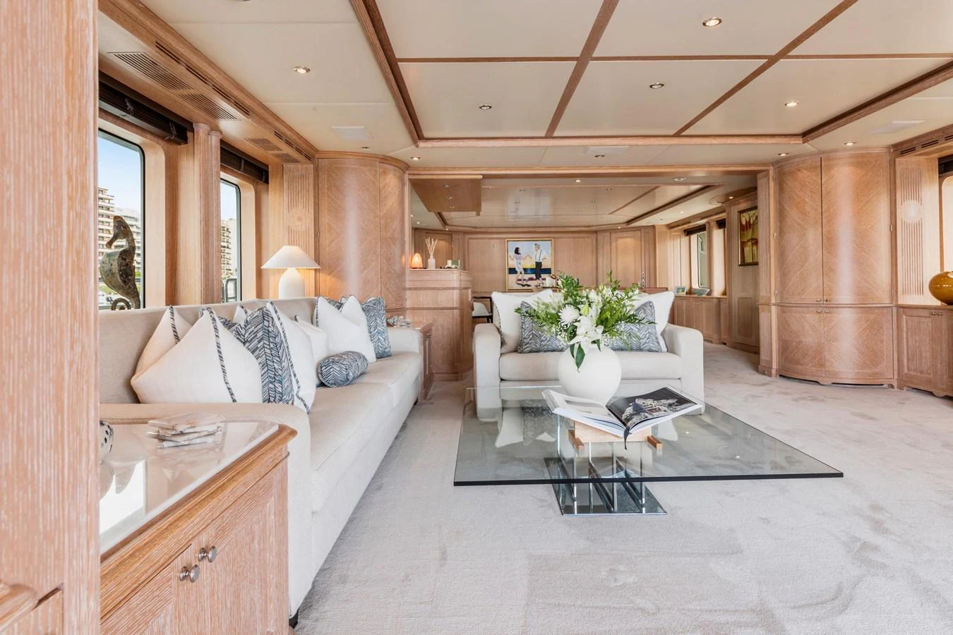 The salon features elegant furnishings and ample natural light, creating a luxurious and inviting atmosphere. aboard SOHO Yacht for Sale