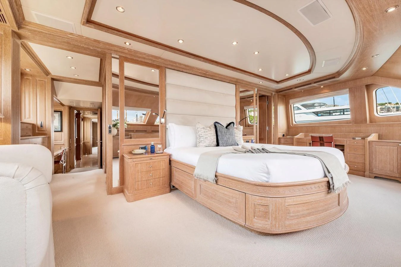 The master stateroom features a spacious and luxurious design with elegant wood finishes and ample natural light. aboard SOHO Yacht for Sale