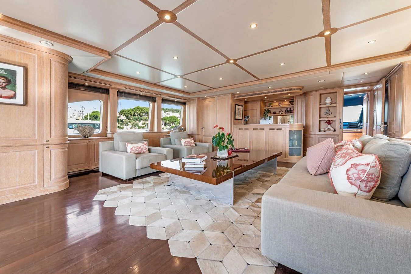 The yacht's salon features elegant wood paneling, plush seating, and a sophisticated ambiance. aboard SOHO Yacht for Sale