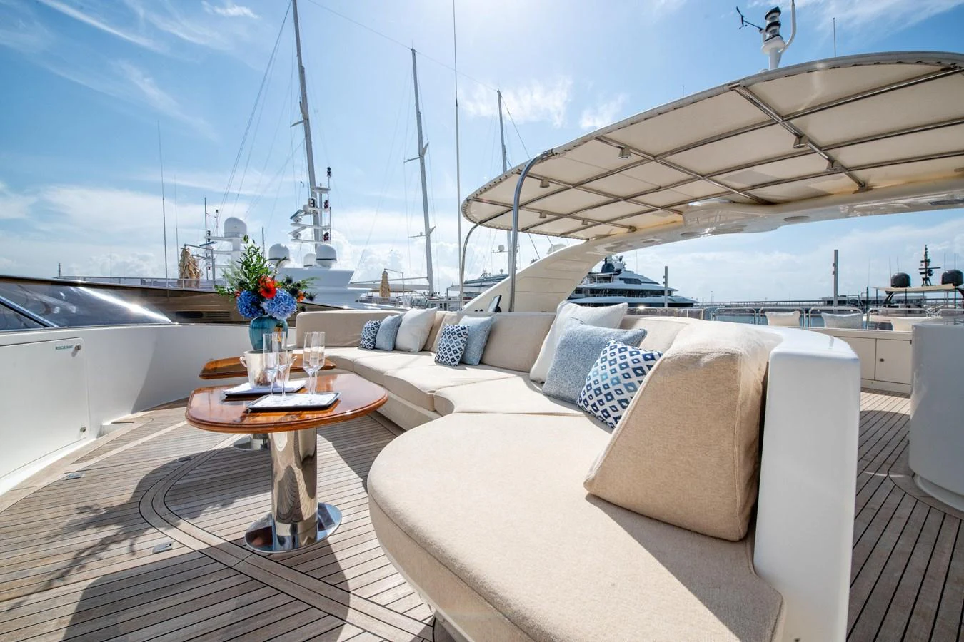 The sundeck offers a luxurious seating area with plush cushions and a stylish table, perfect for relaxation and socializing. aboard SOHO Yacht for Sale