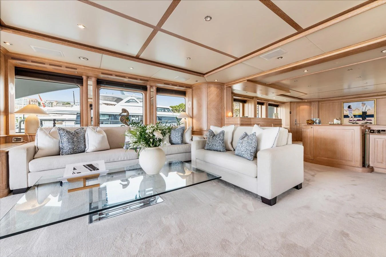 The salon features plush seating, elegant decor, and ample natural light. aboard SOHO Yacht for Sale