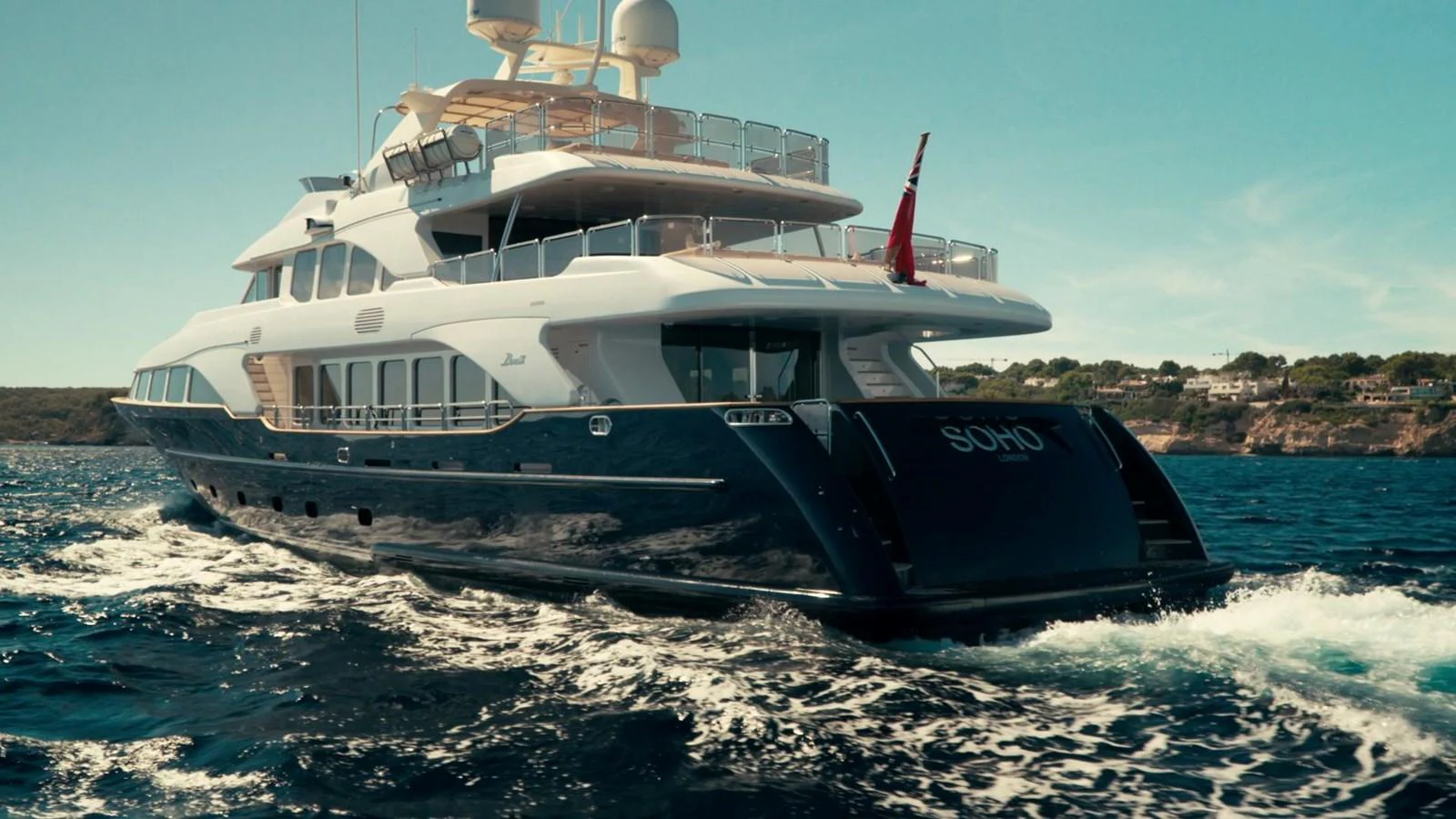 A luxurious yacht cruises through the open water, showcasing its elegant design and spacious decks. aboard SOHO Yacht for Sale