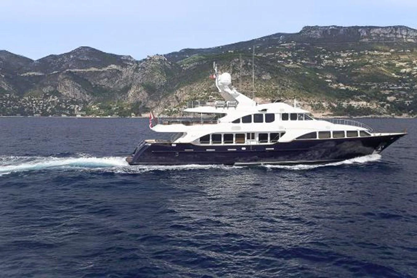 A sleek yacht cruises along the coastline, showcasing its elegant design and luxurious amenities. aboard SOHO Yacht for Sale