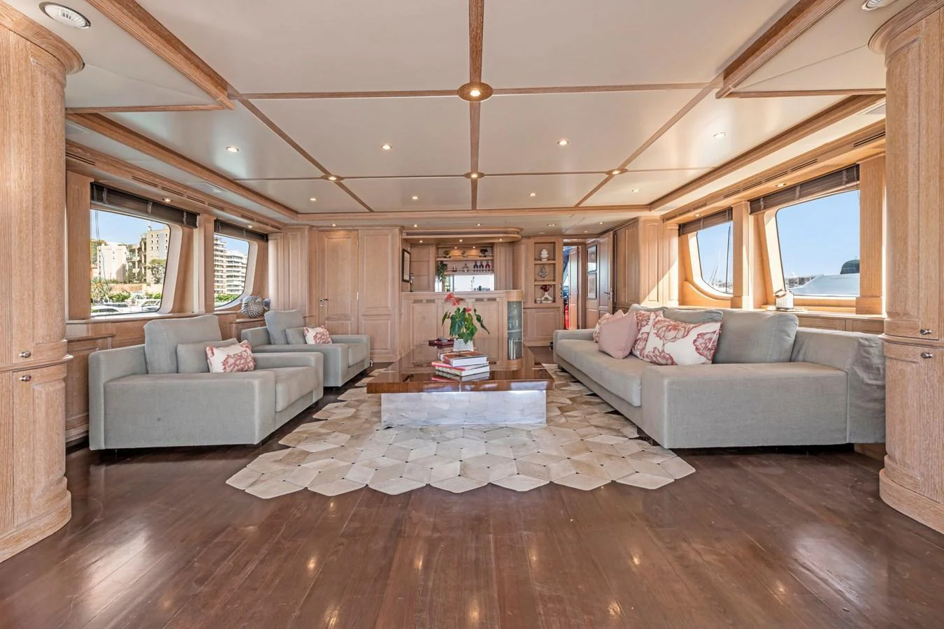The spacious salon features elegant wood paneling and comfortable seating, creating a warm and inviting atmosphere. aboard SOHO Yacht for Sale