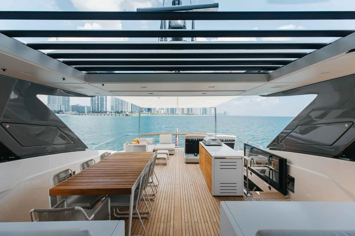 The aft deck offers a spacious and stylish area for dining and relaxation with stunning ocean views. aboard CHAMELEON Yacht for Sale