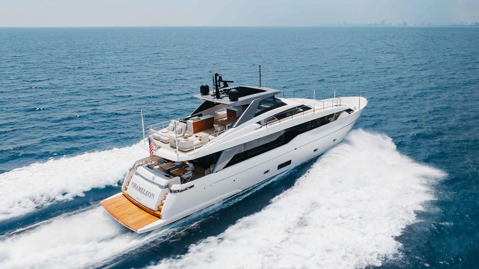 A sleek and modern yacht cruises swiftly through the open sea, showcasing its elegant design and powerful performance. aboard CHAMELEON Yacht for Sale