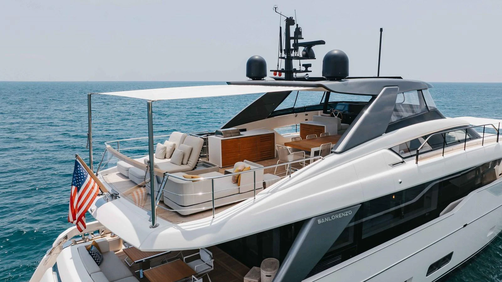 The yacht's aft deck offers luxurious lounging and dining areas with a stunning ocean backdrop. aboard CHAMELEON Yacht for Sale