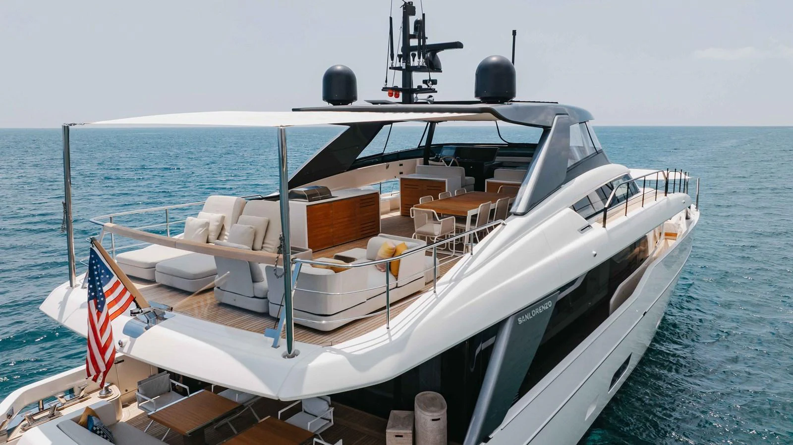 The yacht's aft deck offers a luxurious outdoor lounging and dining area with stunning ocean views. aboard CHAMELEON Yacht for Sale