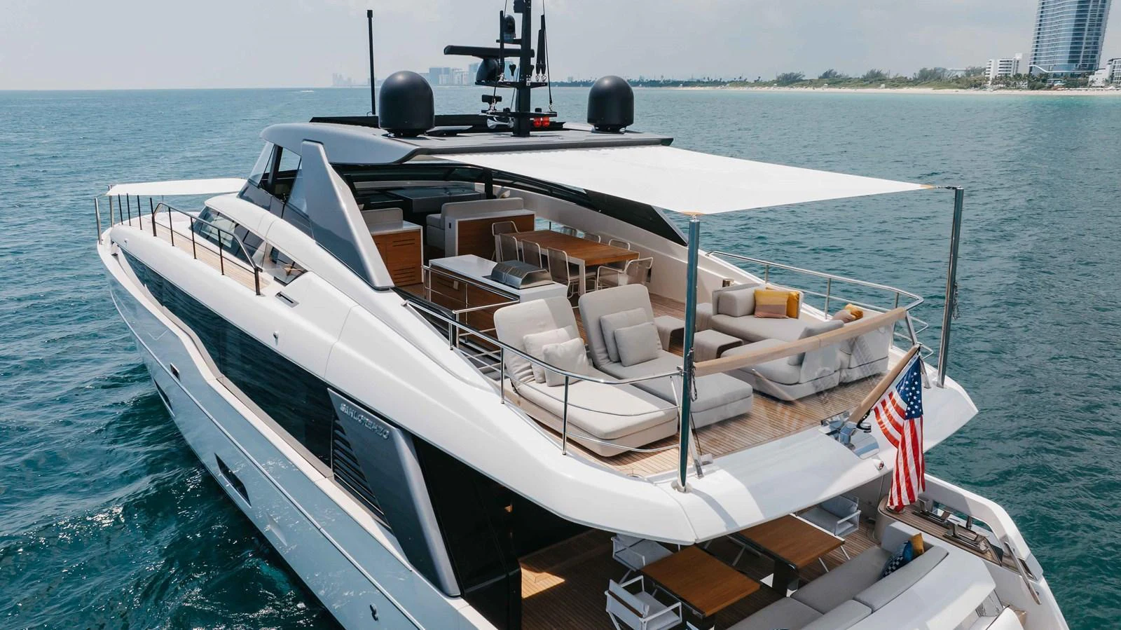 The yacht's aft deck features a spacious lounging area with ample seating and a sunshade, perfect for relaxation. aboard CHAMELEON Yacht for Sale