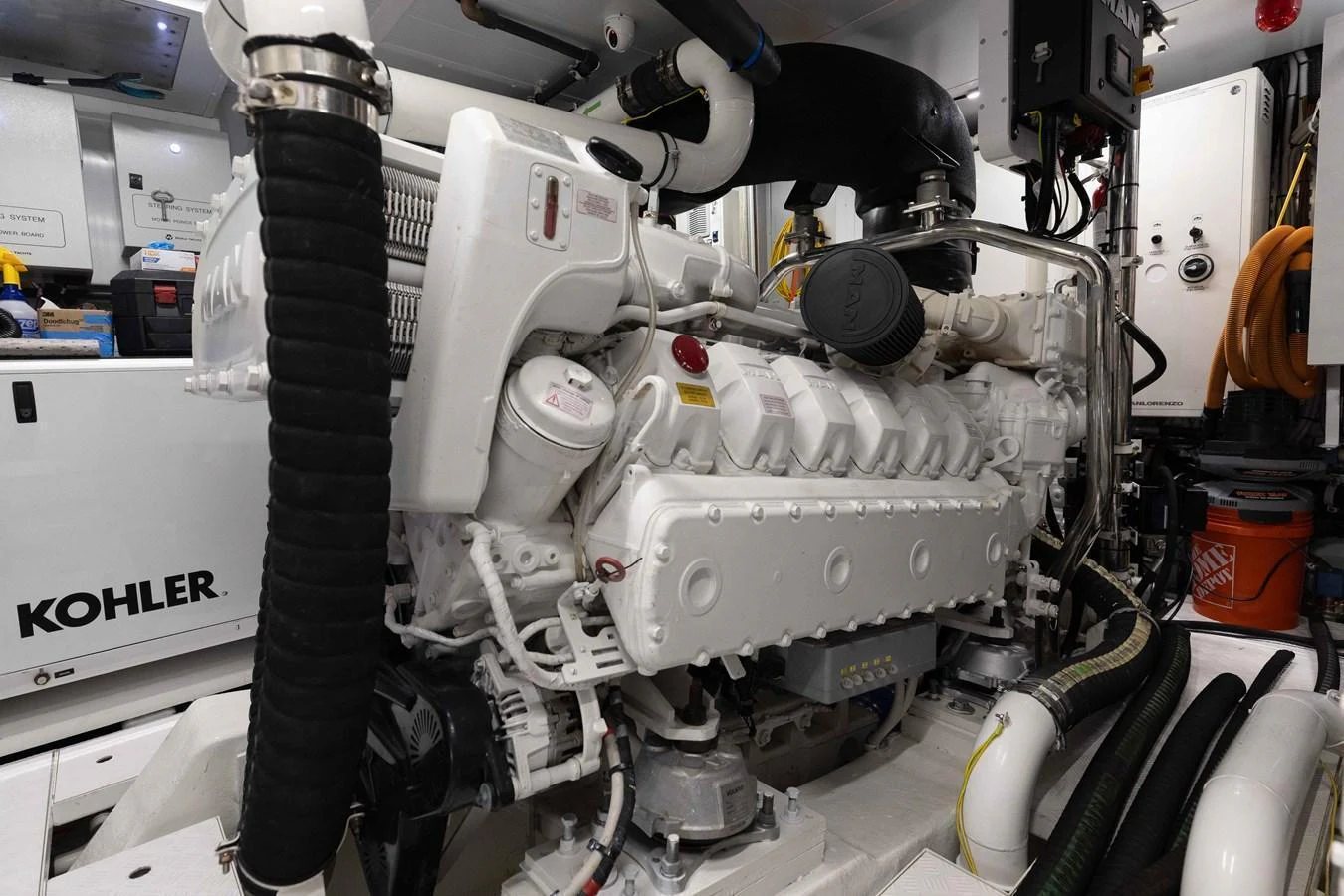 The image showcases the pristine engine room with a powerful Kohler engine. aboard CHAMELEON Yacht for Sale