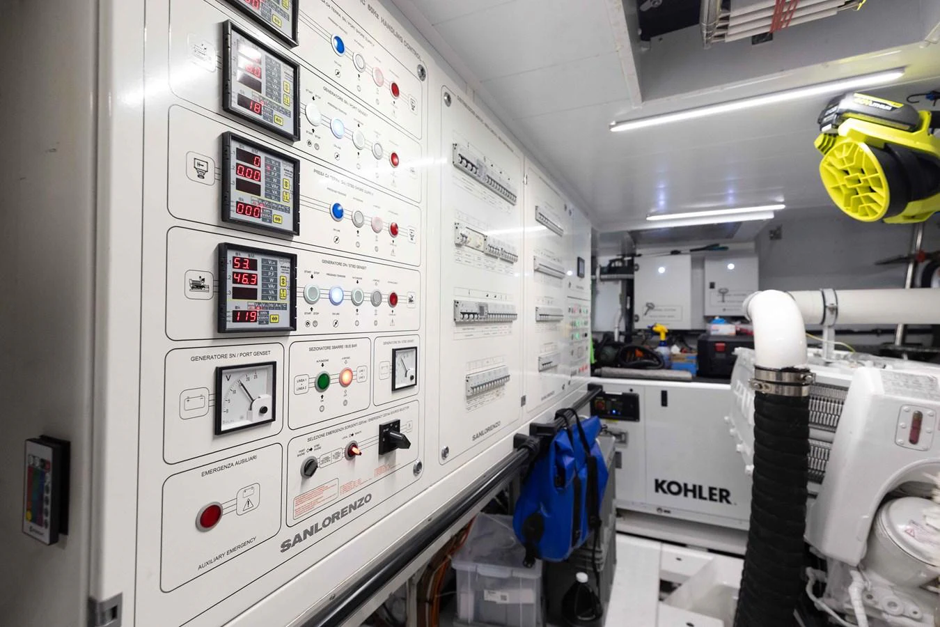 The engine room features a well-organized control panel and essential machinery. aboard CHAMELEON Yacht for Sale