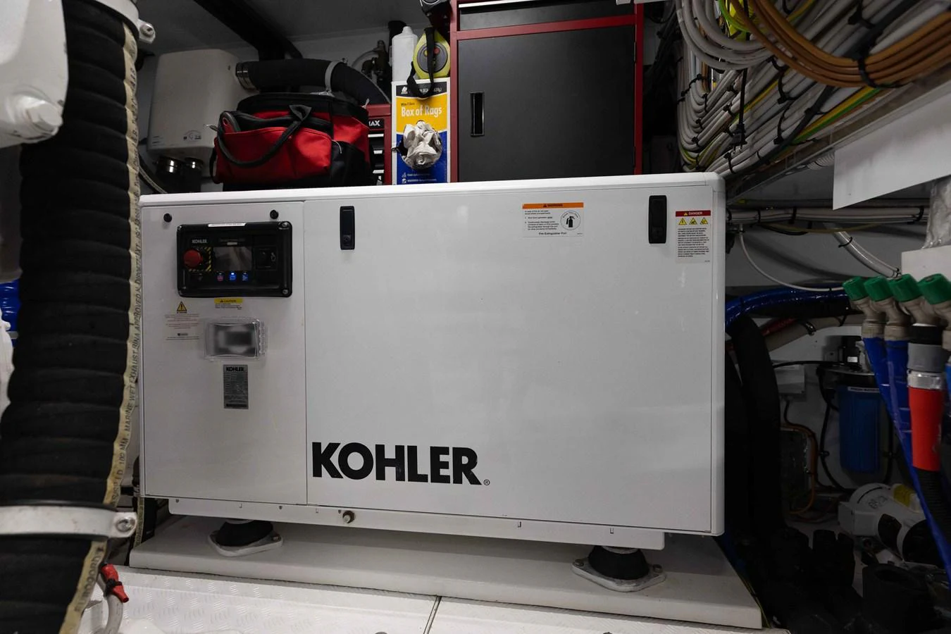 The image showcases the yacht's engine room with a Kohler generator prominently displayed. aboard CHAMELEON Yacht for Sale