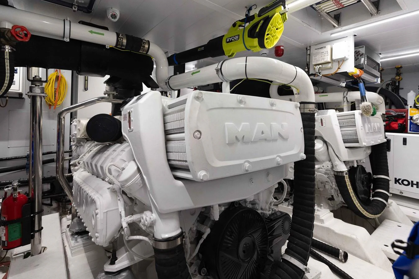 The image showcases the yacht's pristine engine room with powerful MAN engines. aboard CHAMELEON Yacht for Sale