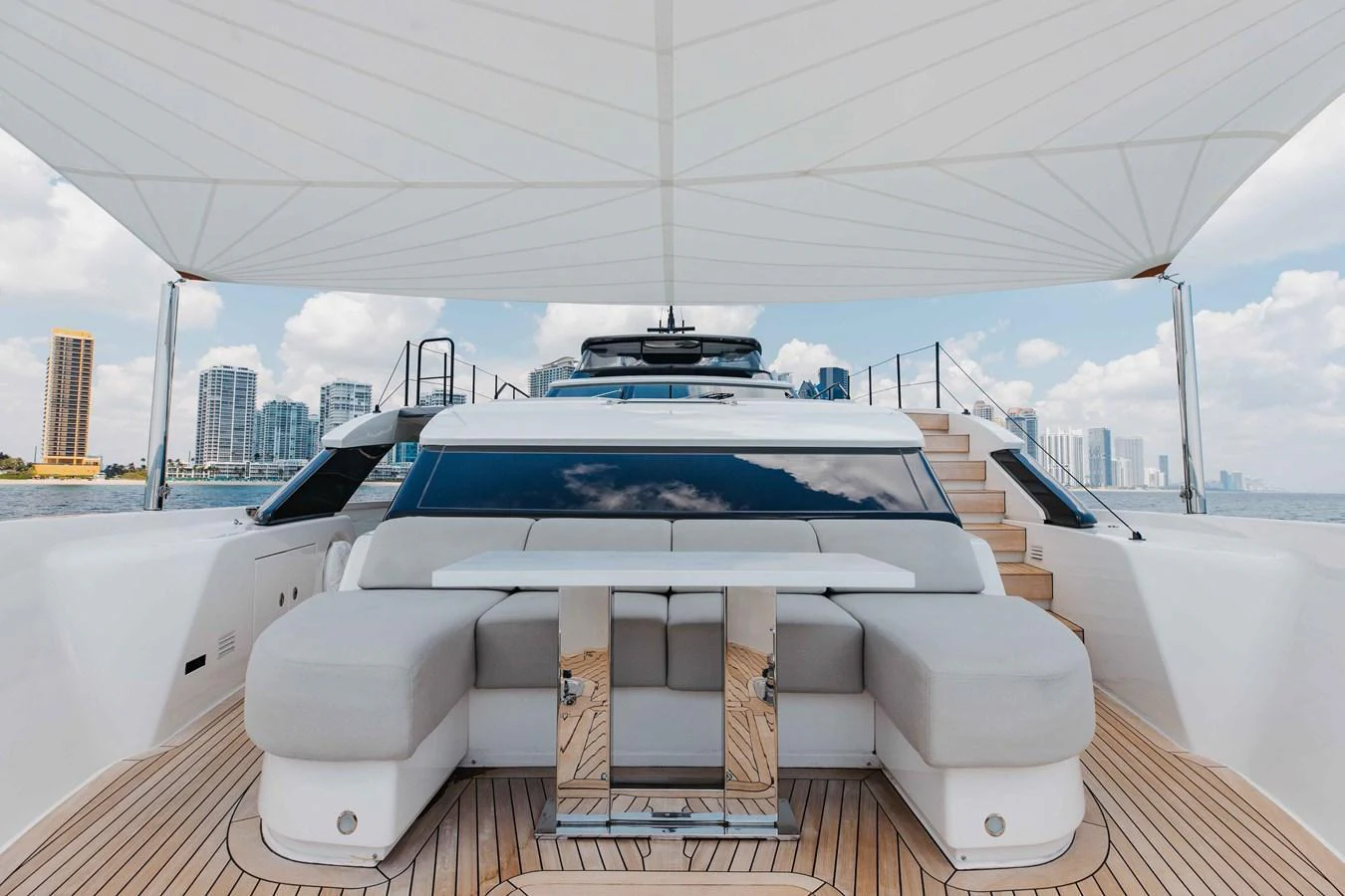 The yacht's flybridge offers a spacious seating area with a modern, shaded design and panoramic views. aboard CHAMELEON Yacht for Sale