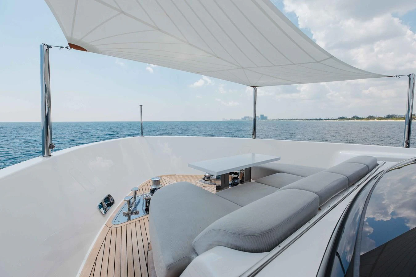 The sundeck offers a comfortable lounging area with a retractable shade for relaxation. aboard CHAMELEON Yacht for Sale