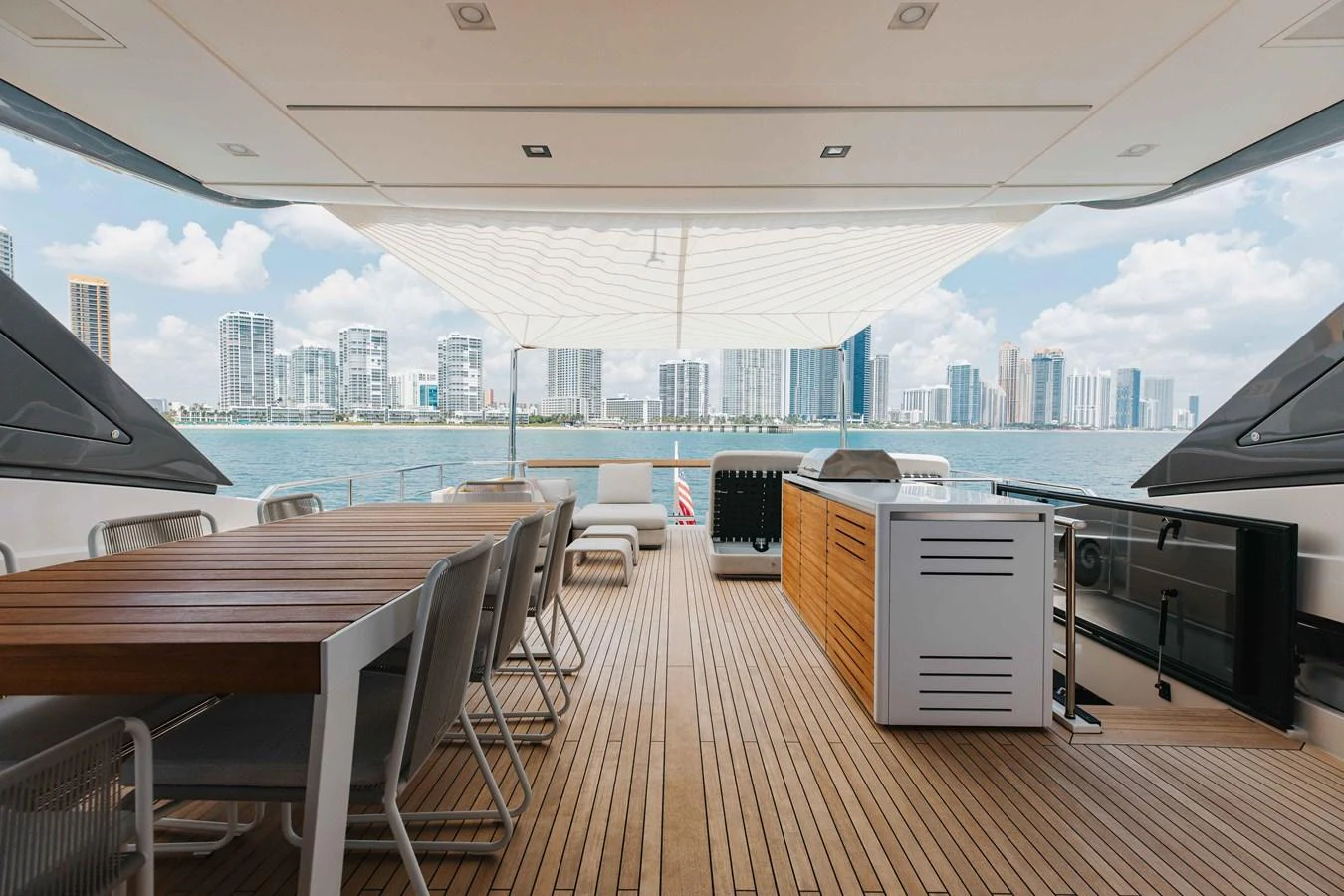 The aft deck offers a spacious and elegant outdoor dining area with stunning views of the city skyline. aboard CHAMELEON Yacht for Sale