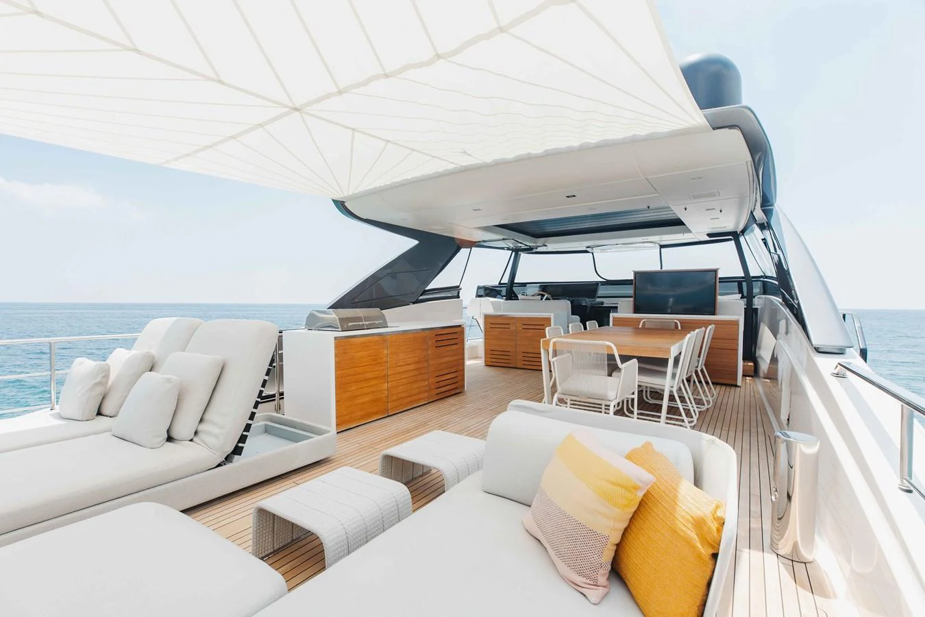 The flybridge offers a luxurious outdoor living space with ample seating and a shaded area for relaxation. aboard CHAMELEON Yacht for Sale
