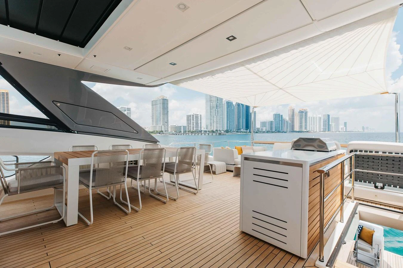 The aft deck offers a spacious and stylish area for alfresco dining and relaxation with stunning cityscape views. aboard CHAMELEON Yacht for Sale