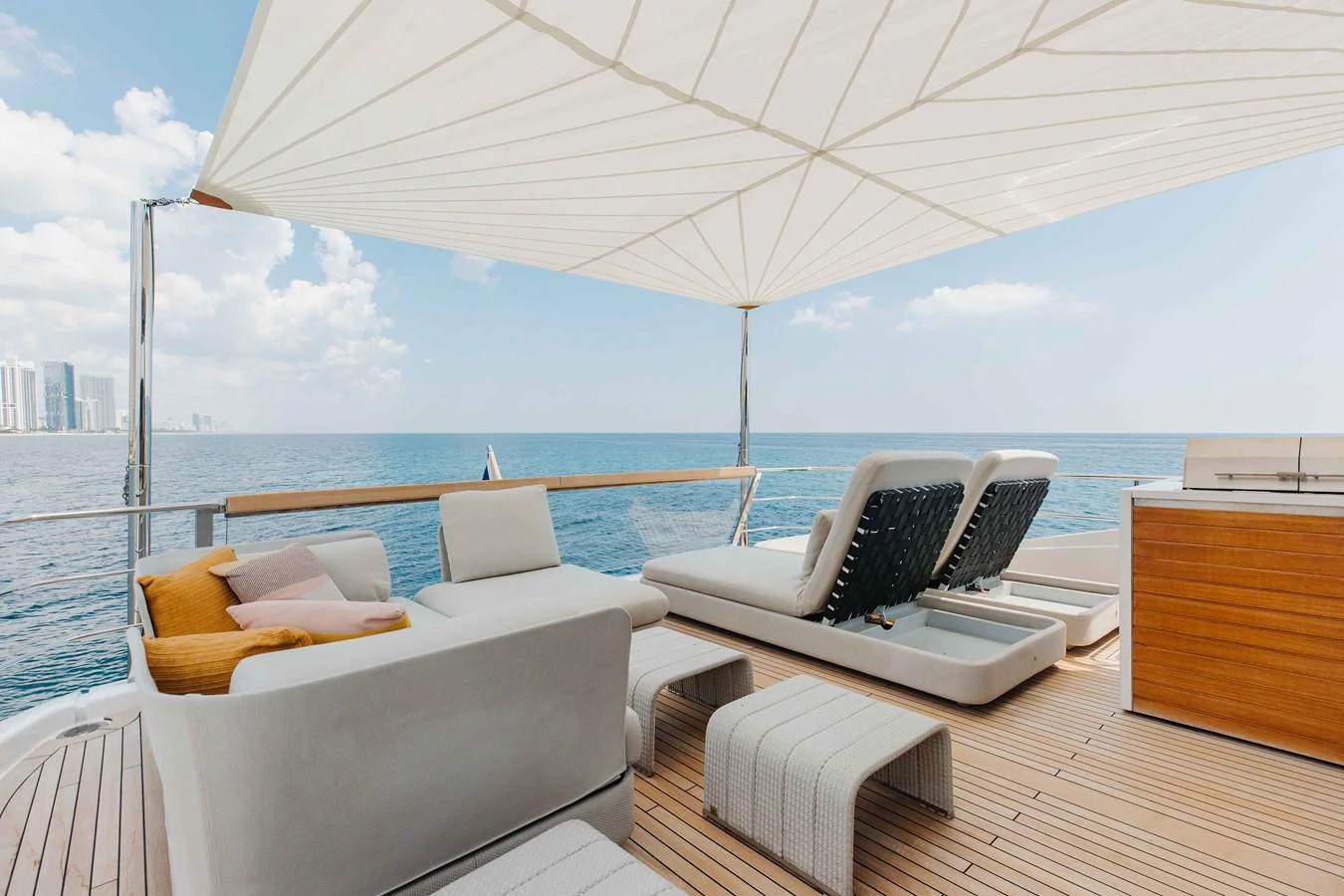 The sundeck offers a luxurious space with comfortable seating and sun loungers under a large canopy, perfect for relaxation and enjoying the ocean view. aboard CHAMELEON Yacht for Sale