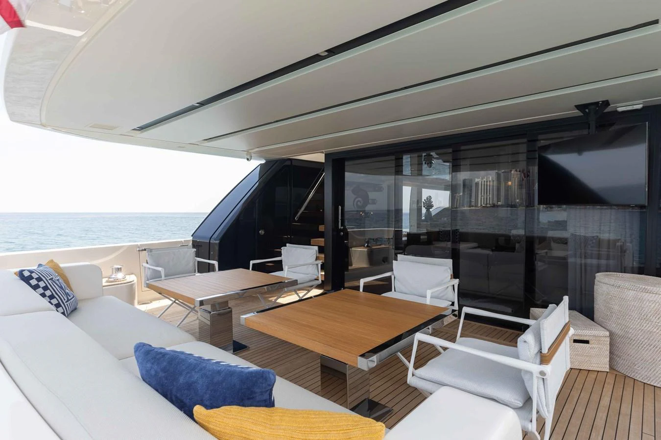 The aft deck offers a spacious and comfortable outdoor seating area with a view of the sea. aboard CHAMELEON Yacht for Sale