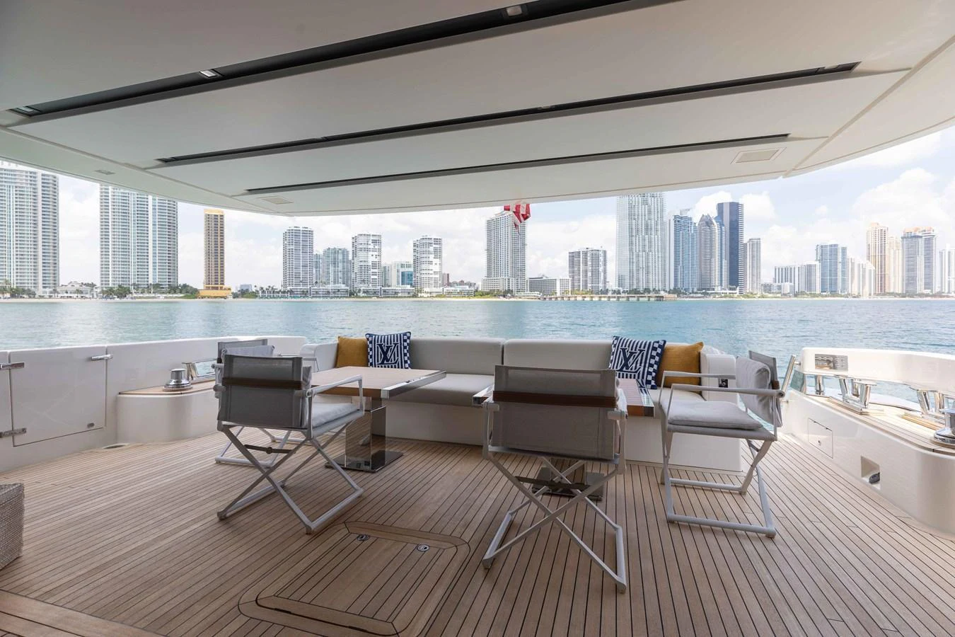 The aft deck offers a spacious and stylish outdoor seating area with a stunning cityscape view. aboard CHAMELEON Yacht for Sale